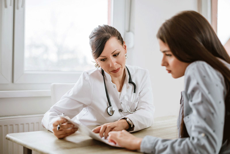 female-doctor-talking-with-patient-about-features-of-electronic-health-records